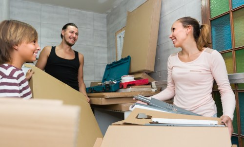 Removal team loading household items into a moving van
