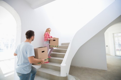 Moving team managing stairs and access in a West London apartment building