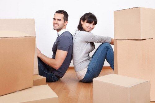 Professional movers handling furniture in a London flat
