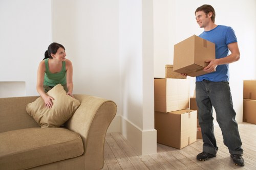 Packed moving boxes and furniture ready for collection in Earls Court